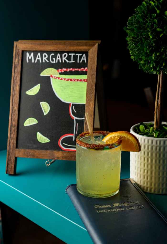 margarita on a bar with sign behind
