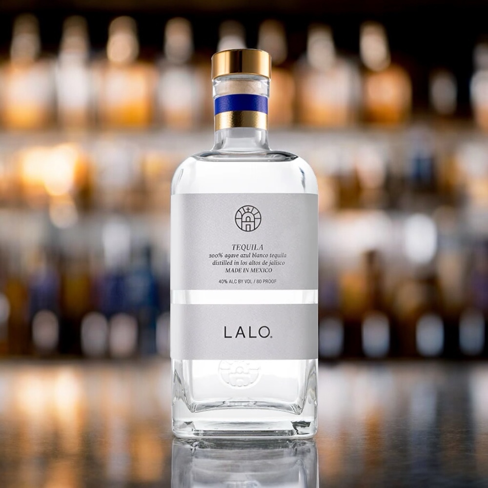 Lalo Tequila blanco standing on the counter of a bar, AgavePassion